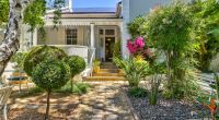 The charming main entrance of Parker Cottage, accented by an array of colorful flowers and plants that enhance the welcoming atmosphere of our Cape Town B&B.