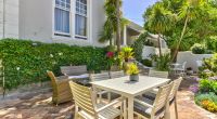 A tranquil patio lounge area at Parker Cottage, featuring plush seating and stylish outdoor decor, perfect for soaking up the sunny Cape Town weather.